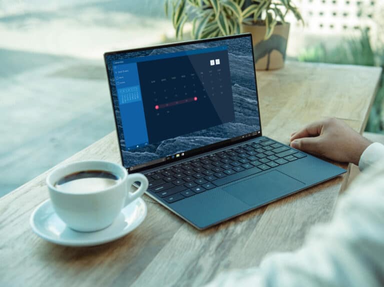 Image of a laptop with calendar and cup of coffee